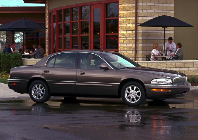 Full-size sedan side profile with alloy wheels and four doors