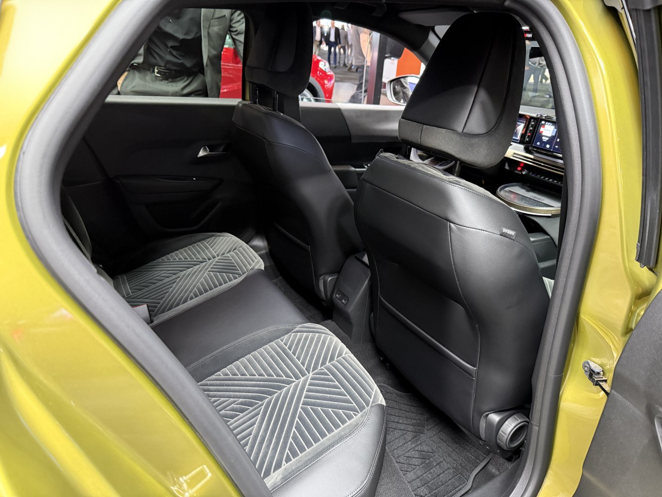 Rear seat interior with patterned upholstery and black leather backs