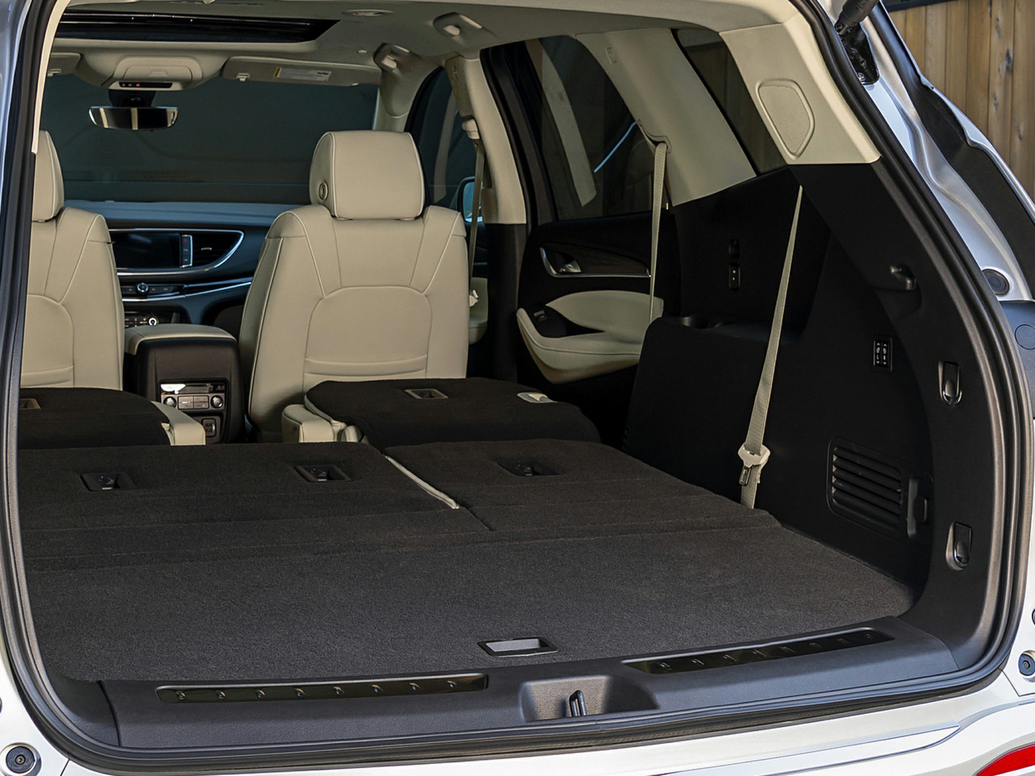 Spacious SUV cargo area with folded rear seats and beige interior