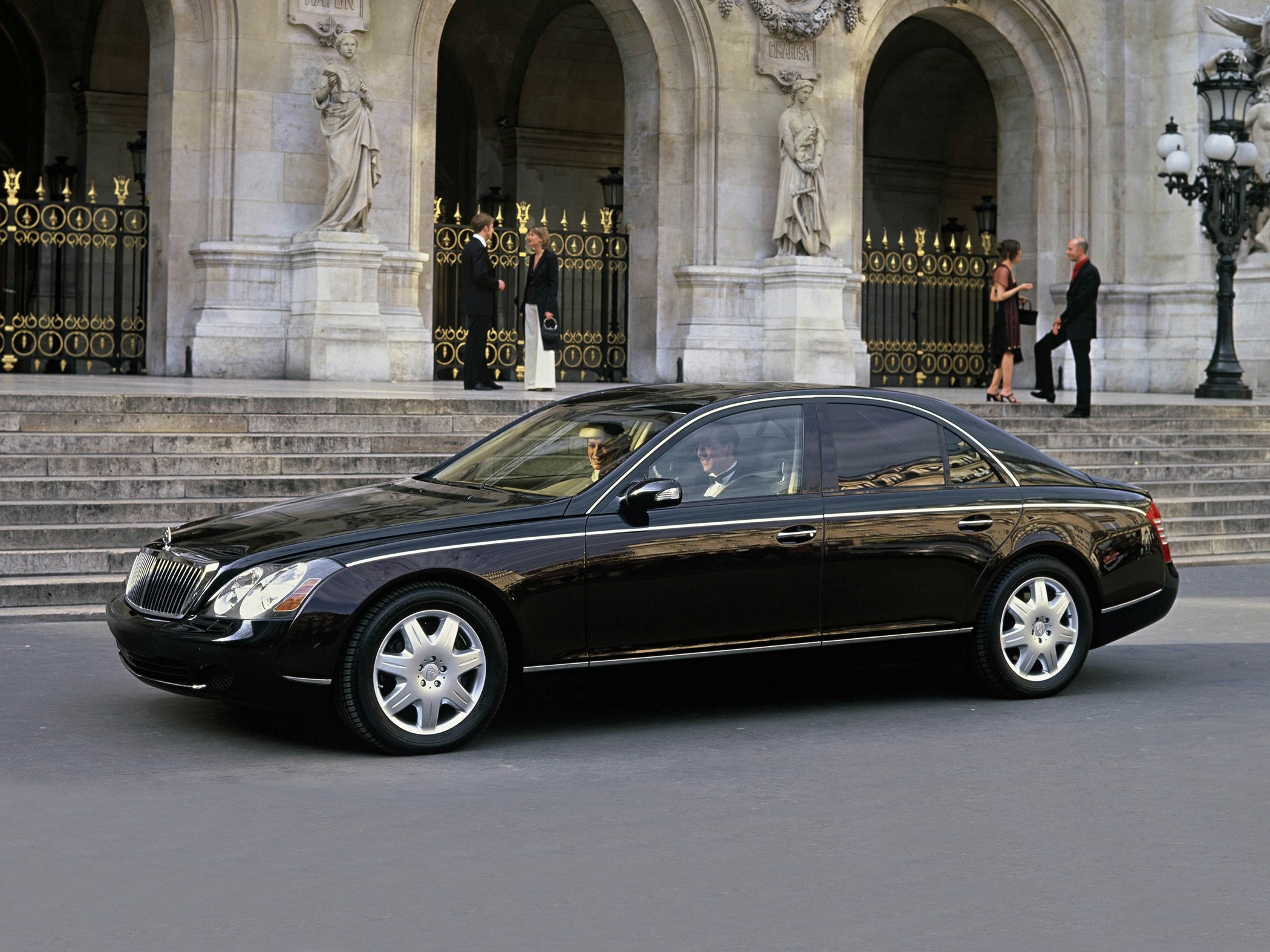 Black luxury sedan with vertical grille and alloy wheels