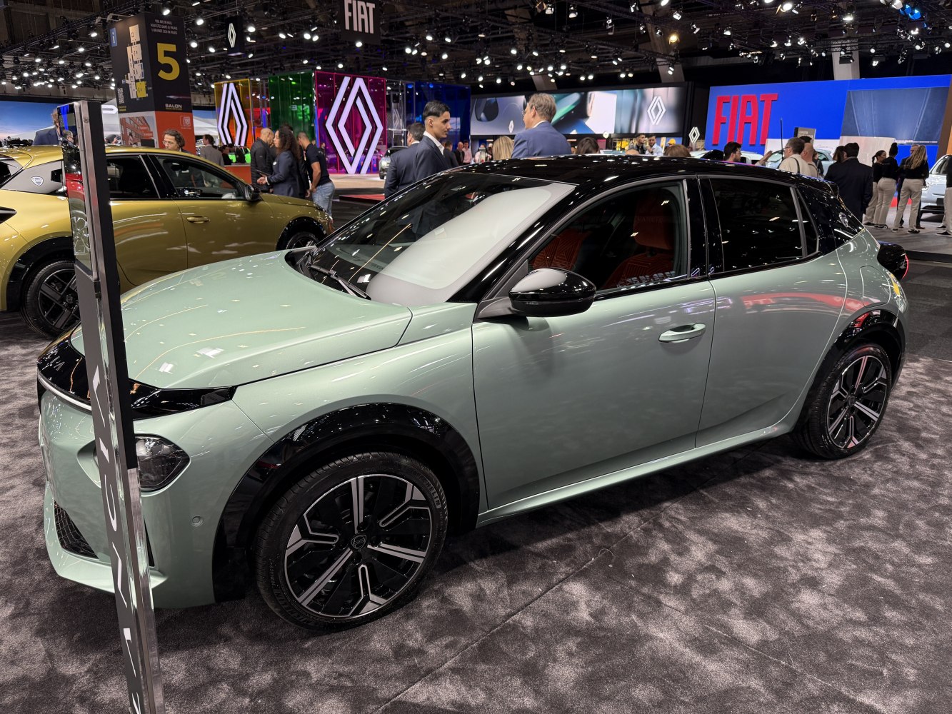 Front side view of a sleek hatchback with modern wheels