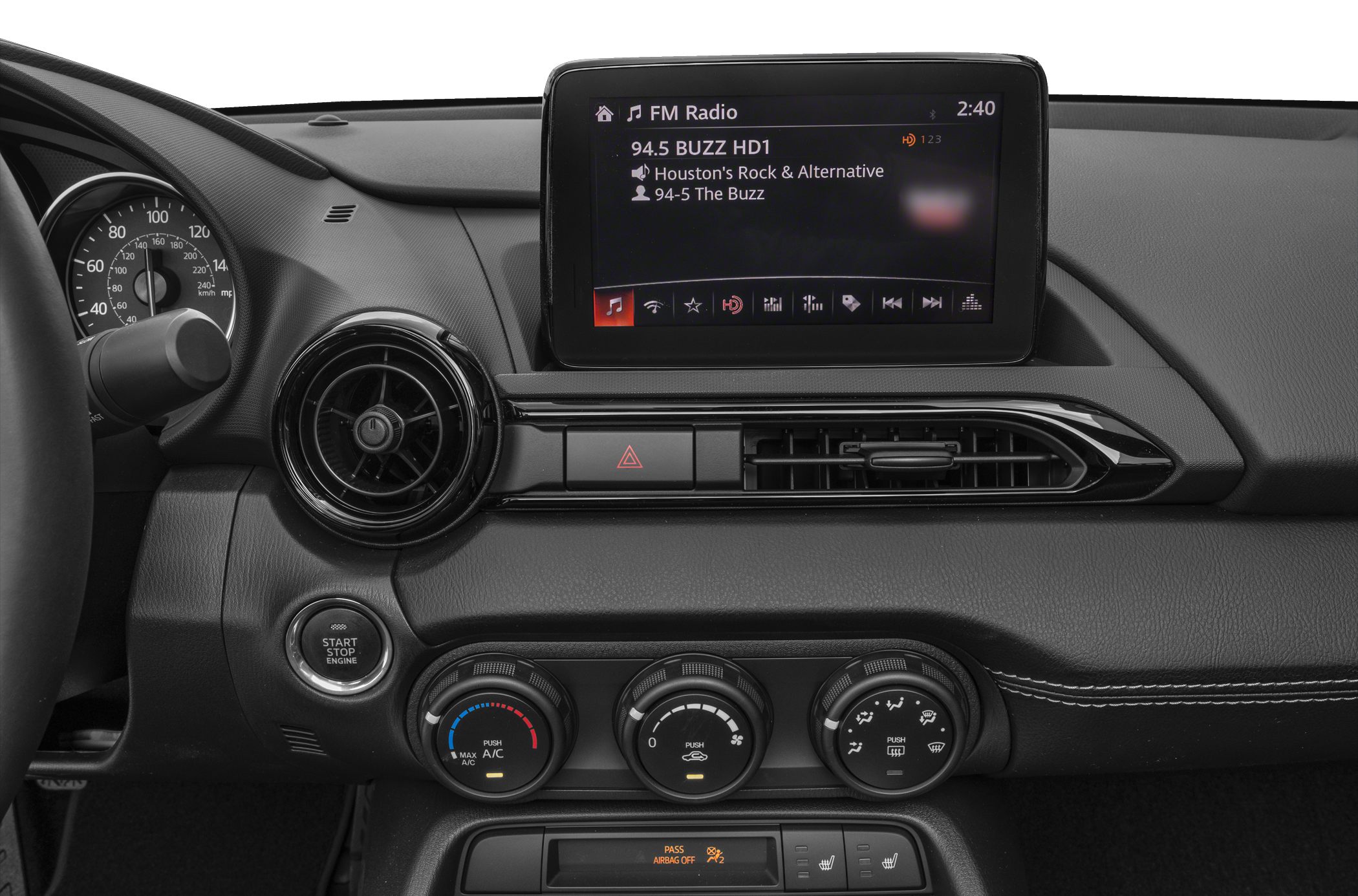 Infotainment screen, circular air vents, climate control knobs, push start button