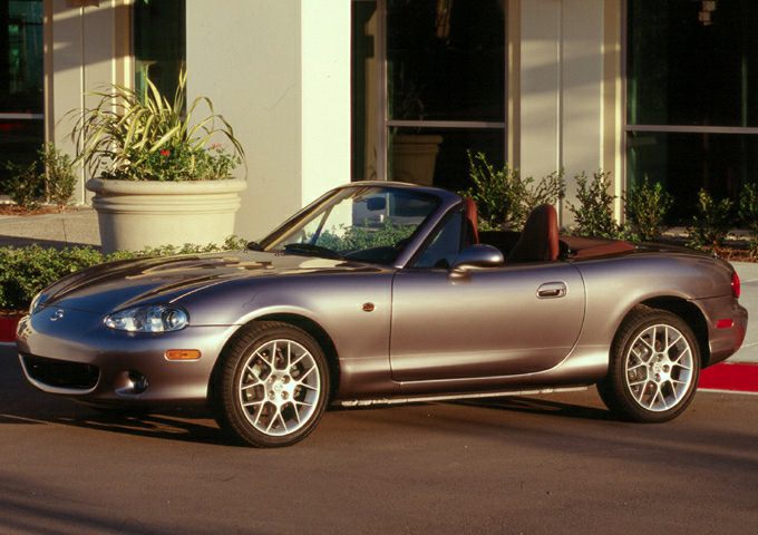 Sporty two-door convertible with alloy wheels and an open-top design.