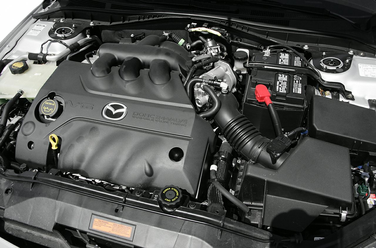 Close-up of a Mazda V6 engine with variable valve timing and DOHC system.
