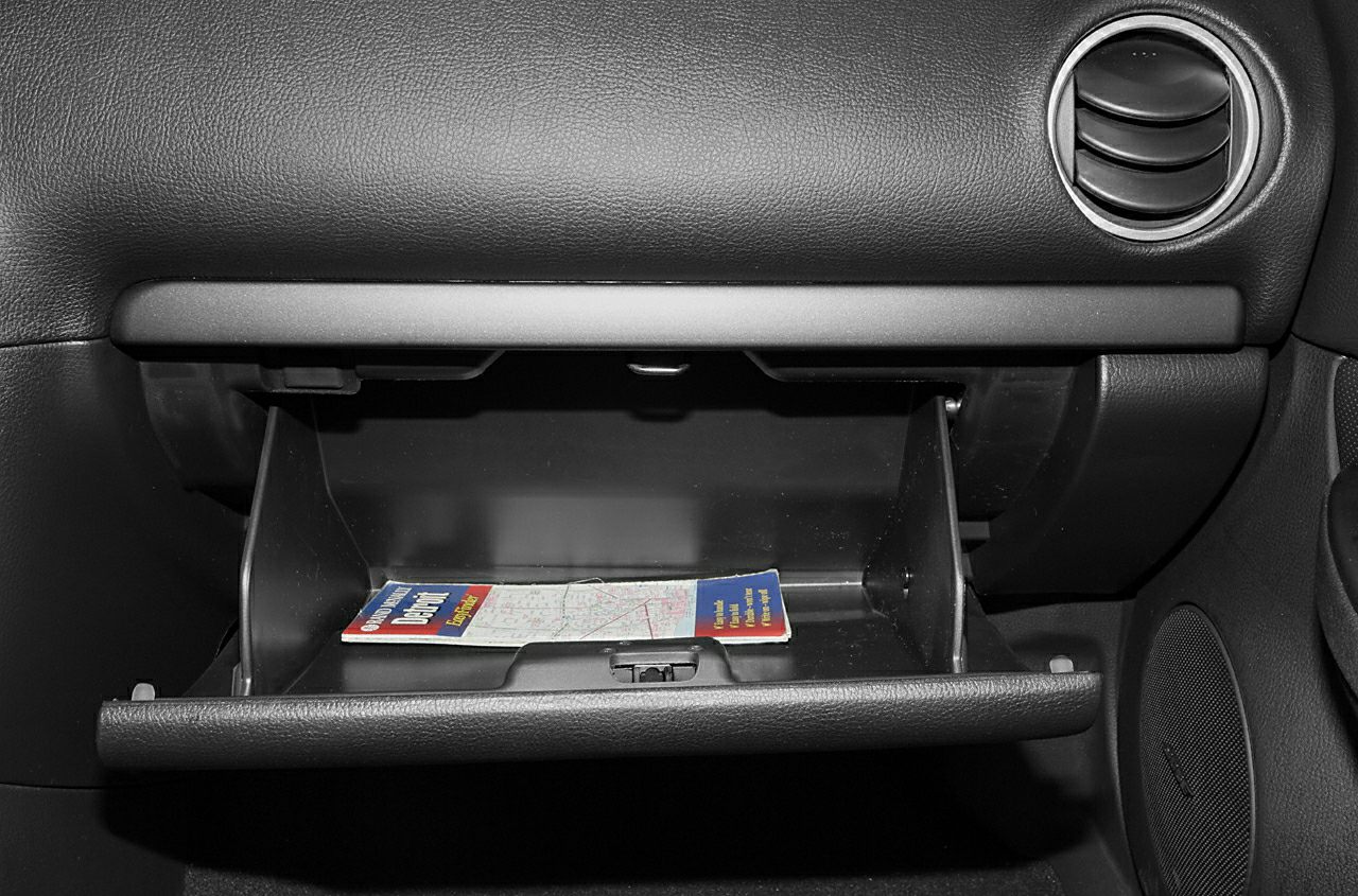 Open glove compartment with dashboard and air vent detail