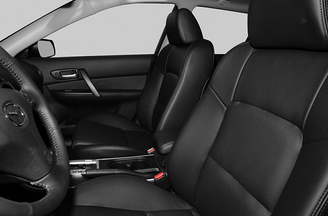 Black leather front seats and steering wheel in car interior