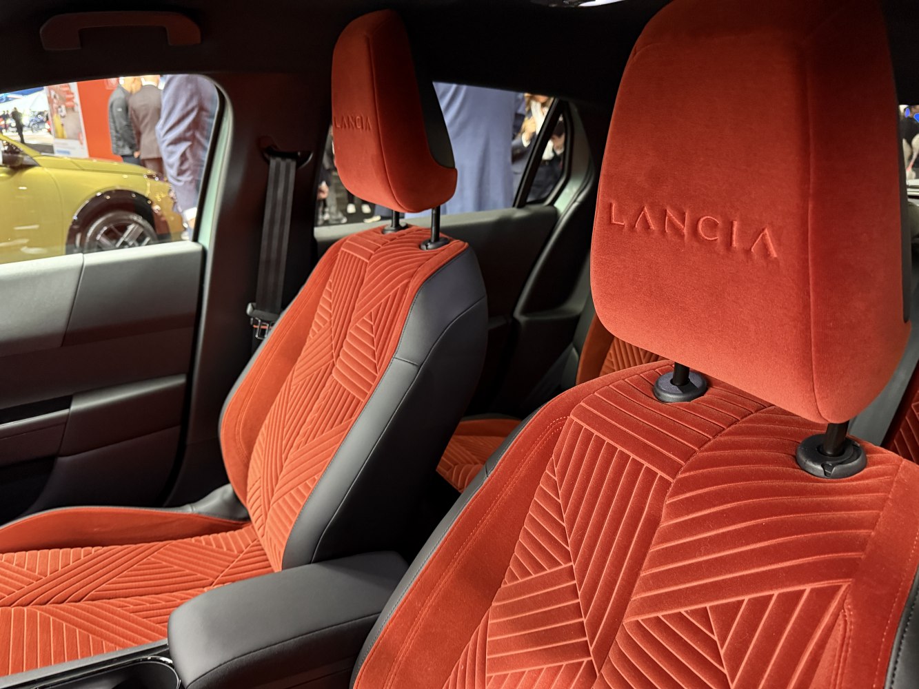 Red fabric seats with embossed logos and detailed patterns