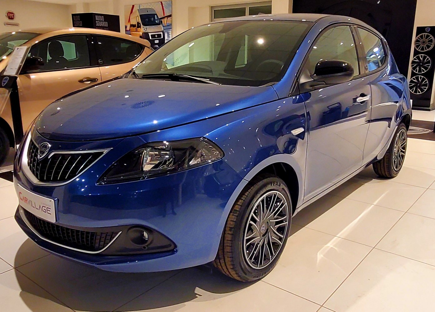 Blue compact hatchback with distinctive front grille and alloy wheels