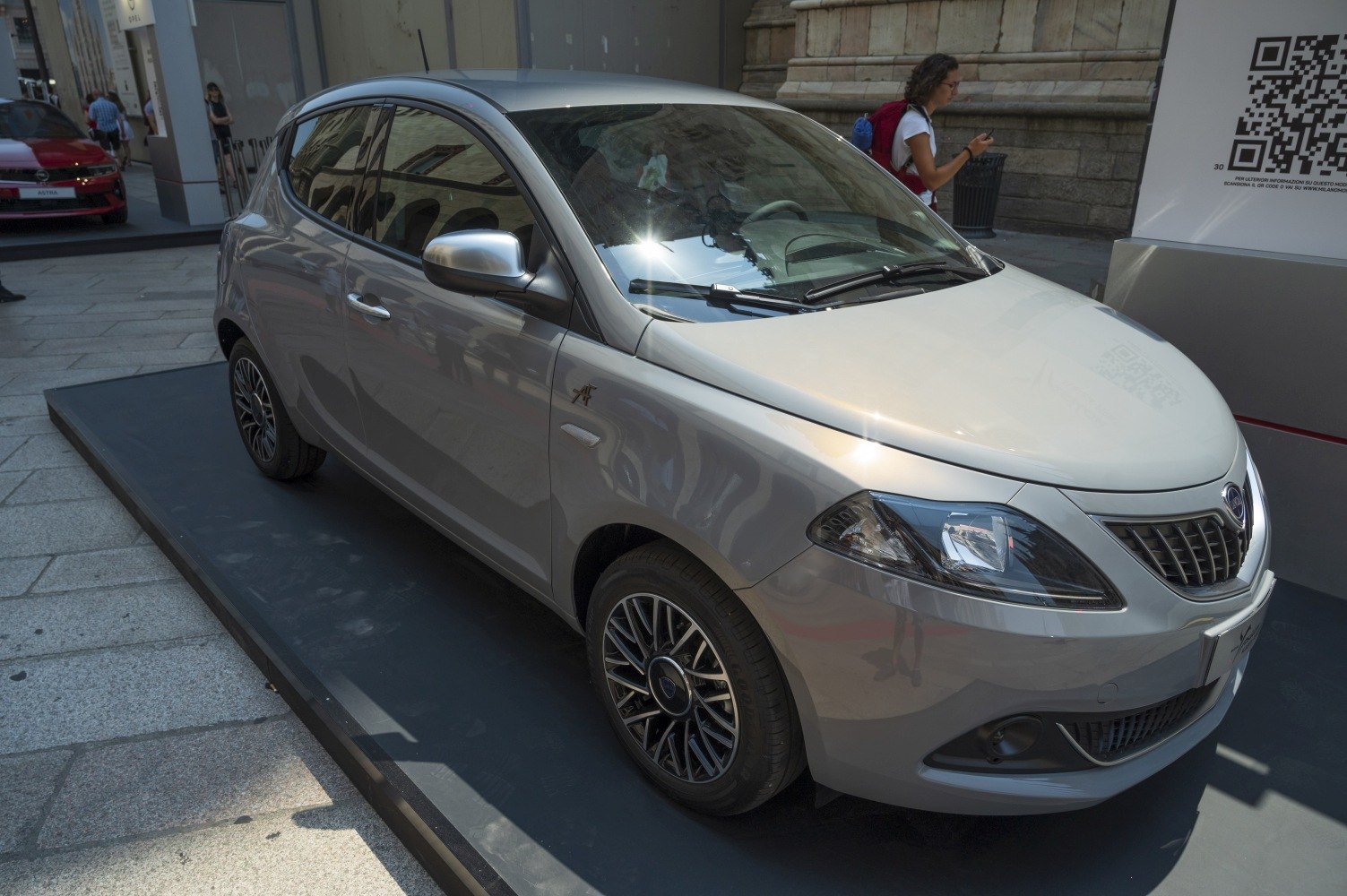 Silver compact hatchback with sleek headlights and alloy wheels