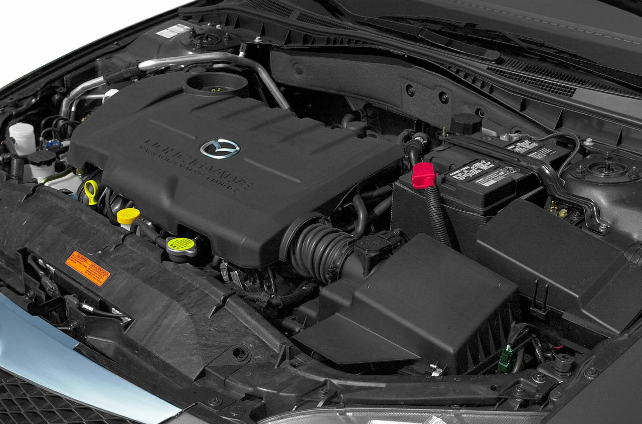 Engine bay with engine cover and battery in focus