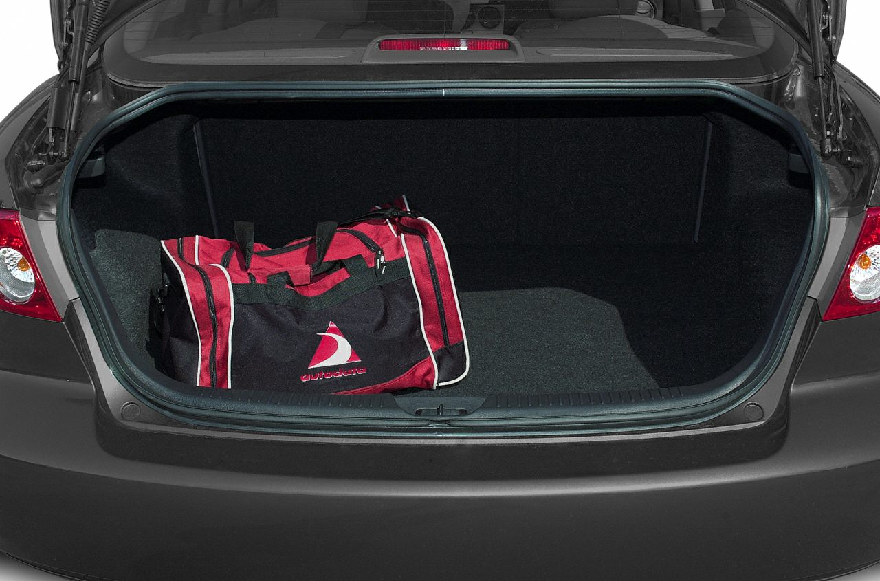 Open sedan trunk with duffel bag and spacious cargo area