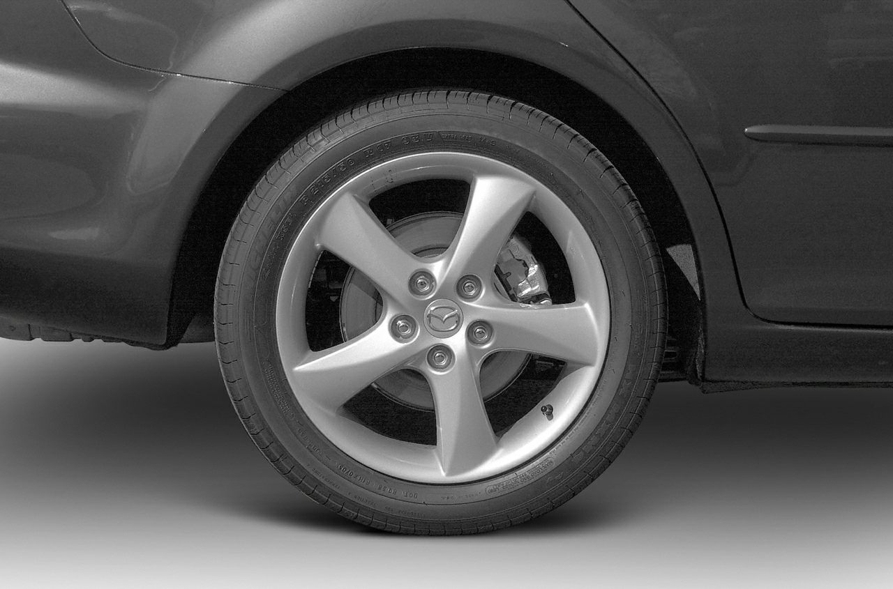 Close-up of alloy wheel with five-spoke rim and visible brake caliper.