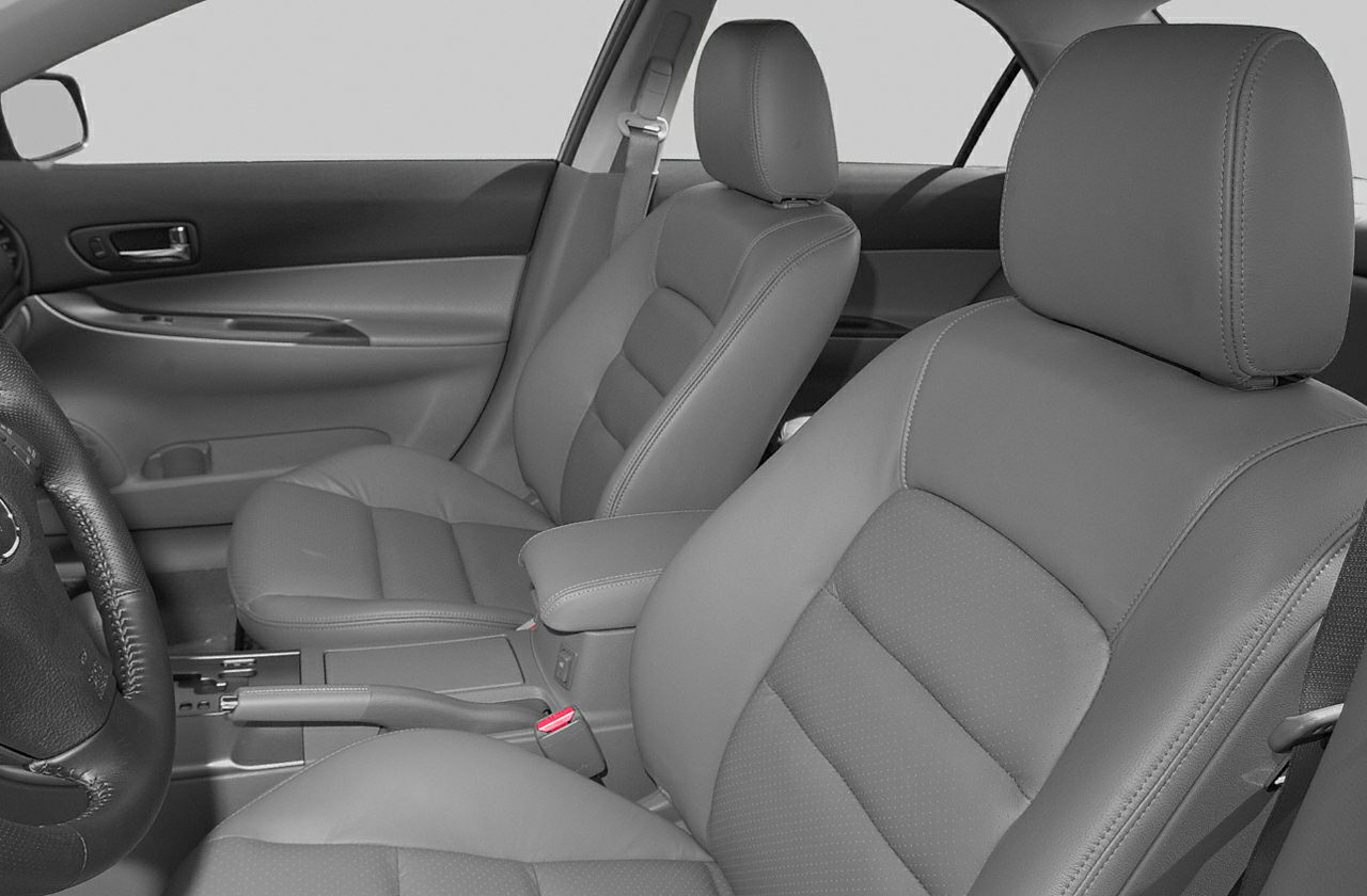 Front seats with seatbelts, door panel, center console, and handbrake