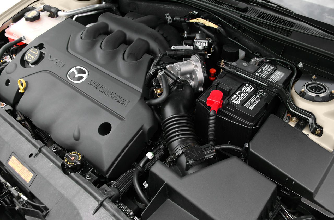 Close-up of V6 DOHC 24-valve engine bay with visible Mazda logo and components