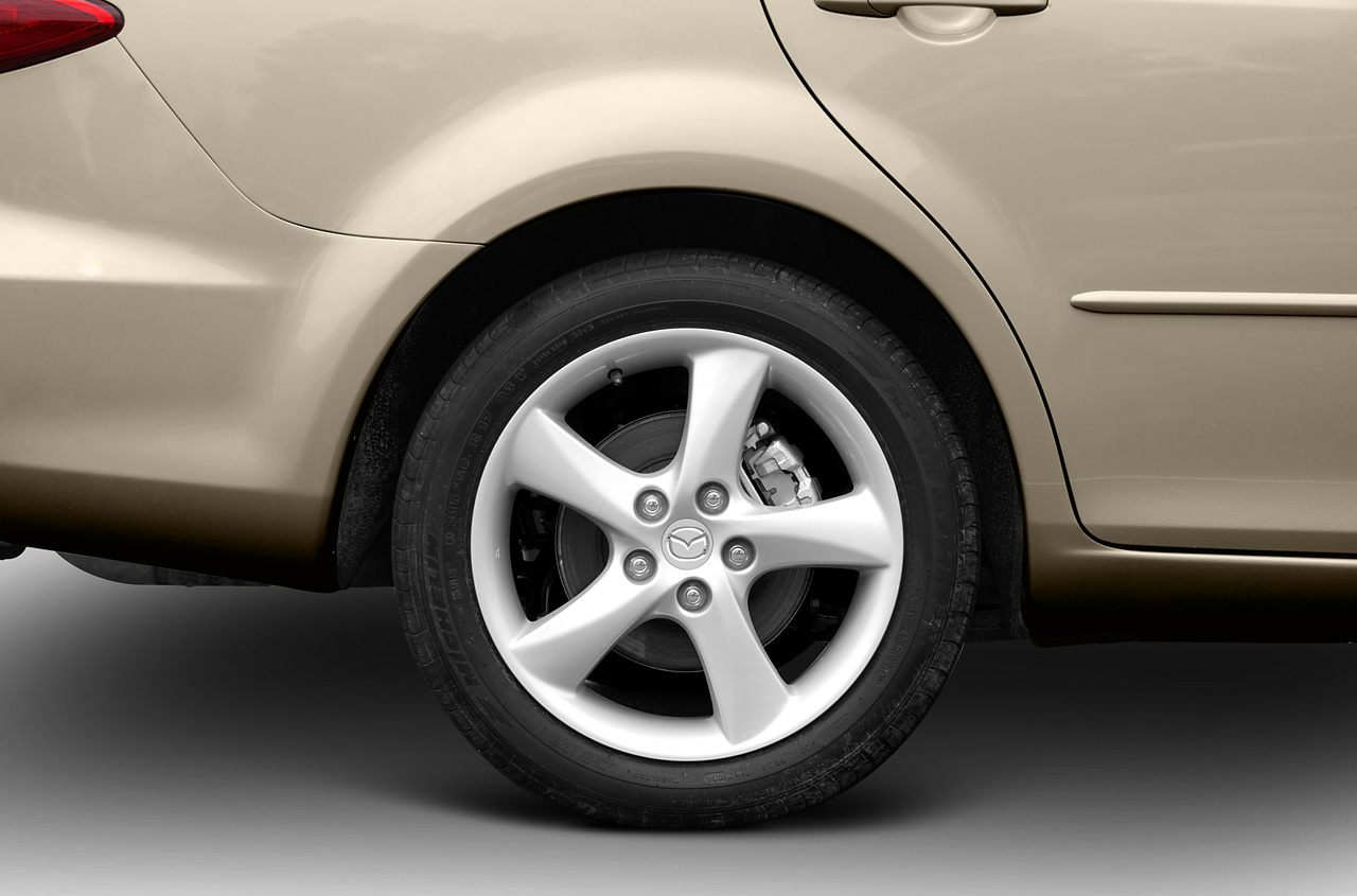 Close-up of rear alloy wheel with visible brake disc and caliper