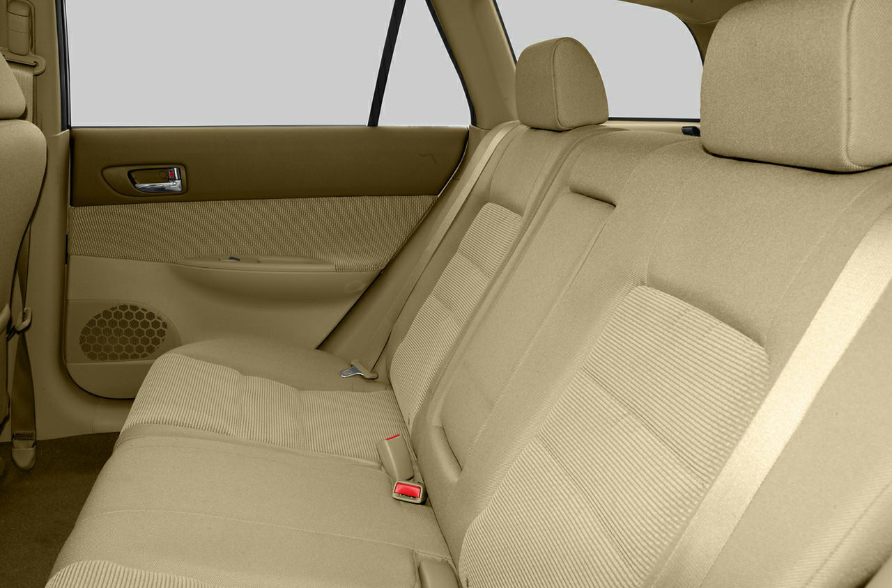 Beige fabric rear seat with headrests and door panel