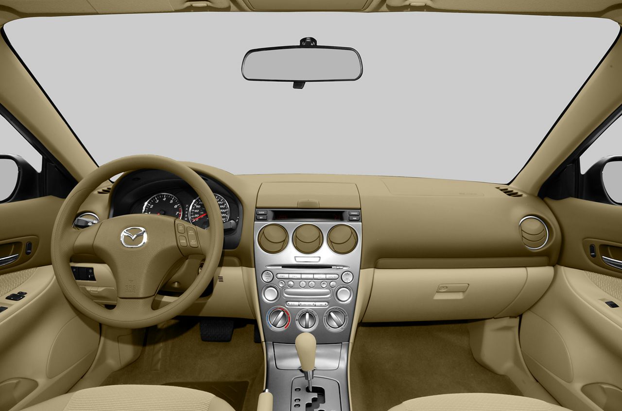 Beige car interior with dashboard, steering wheel, and central control panel