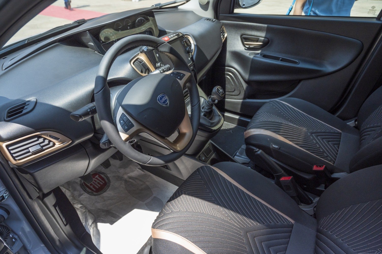 Dashboard, steering wheel, seats, and manual gearstick of a car interior