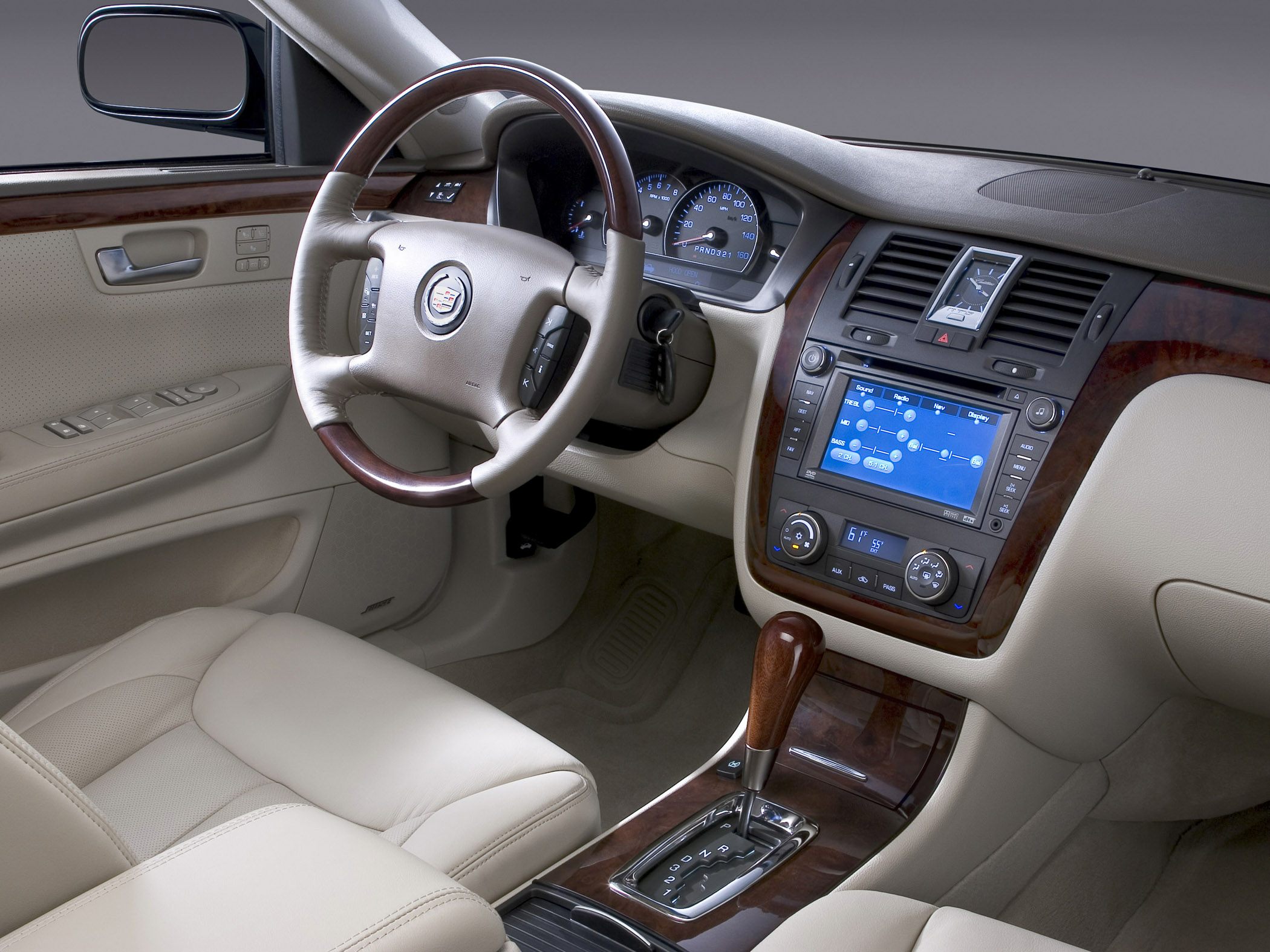 Luxurious interior with wood trim, leather seating, and advanced dashboard controls