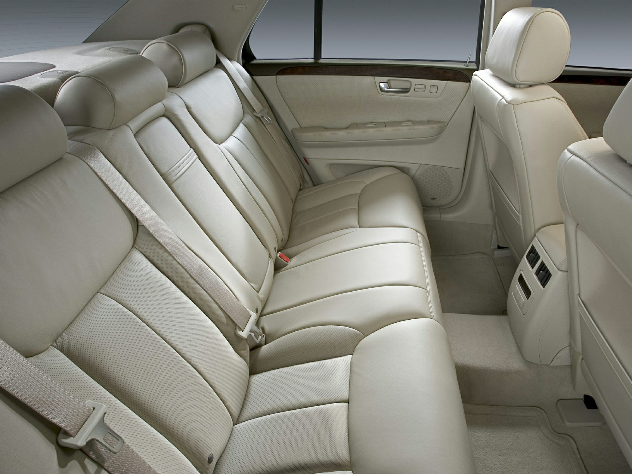 Beige leather rear seats with spacious interior and detailed door panel