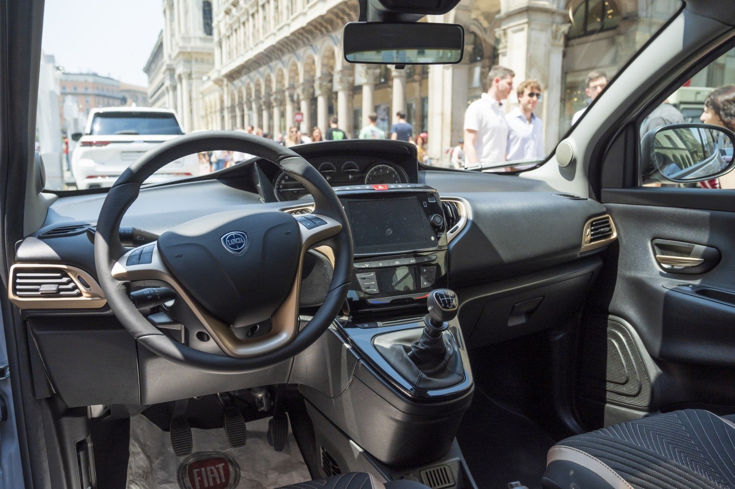 Car interior dashboard with manual gear lever and steering wheel