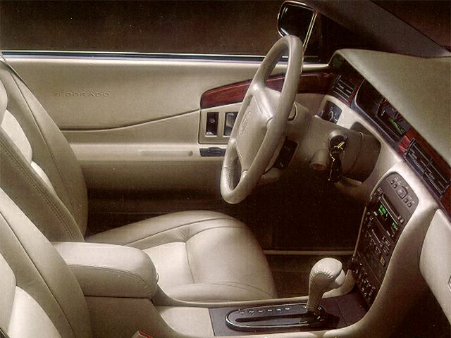 Leather seats and wood trim luxury interior with automatic gear shifter