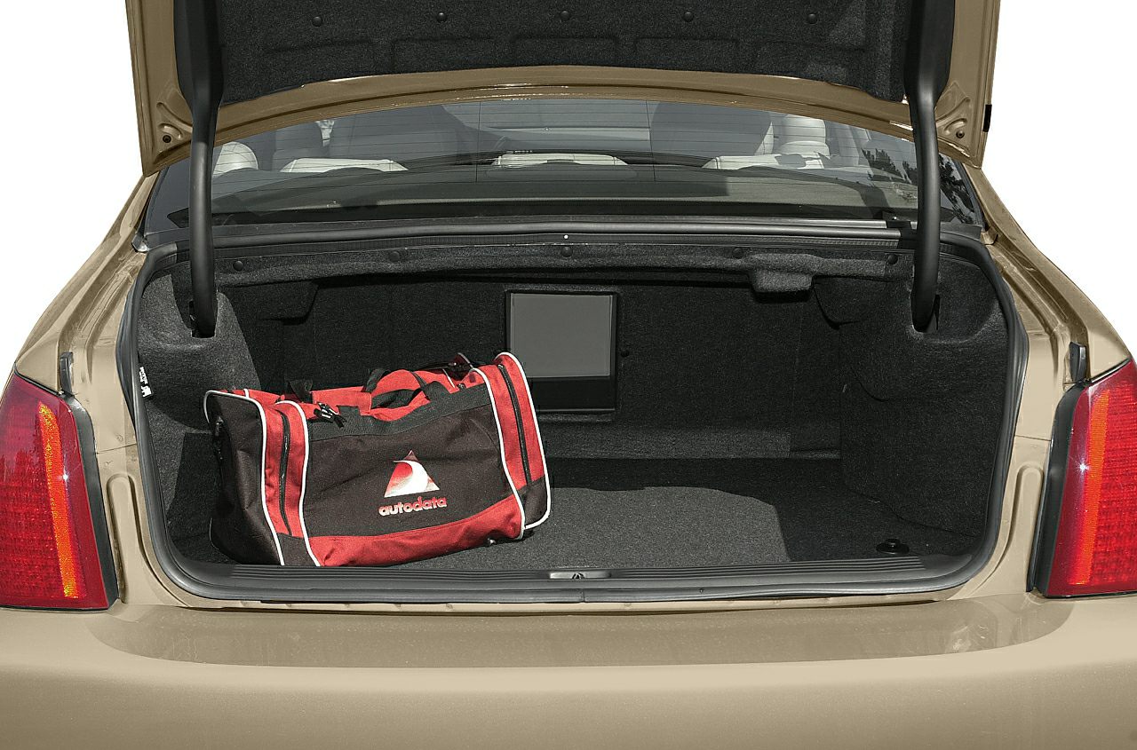 Open car trunk with a red and black travel bag inside