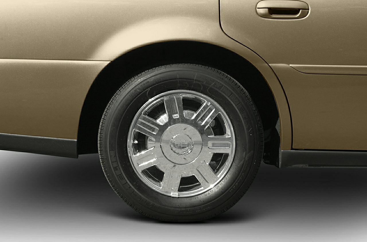Chrome wheel and rear door handle on car body section