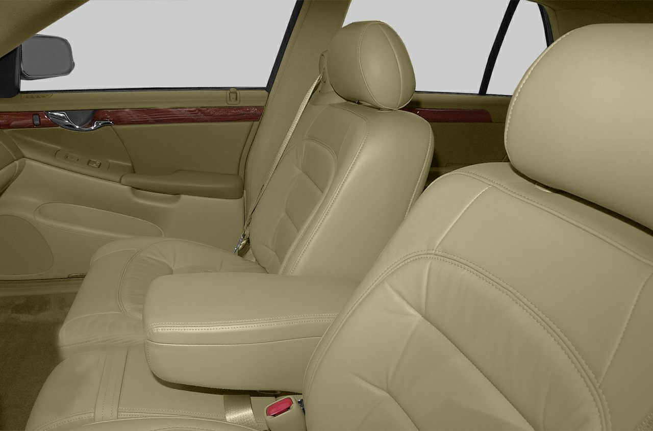 Beige leather seats with wood trim and central armrest