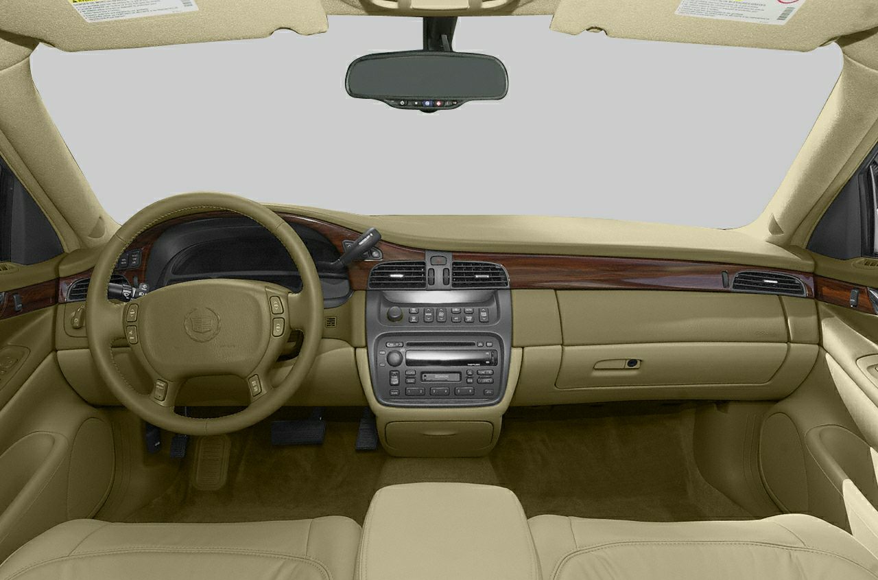 Beige interior dashboard with wood trim and multifunction steering wheel