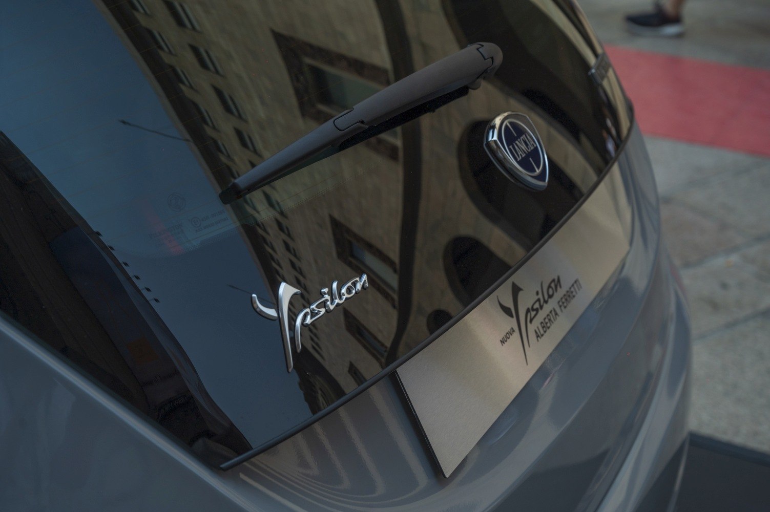 Close-up of a car rear wiper, badge, and rear window
