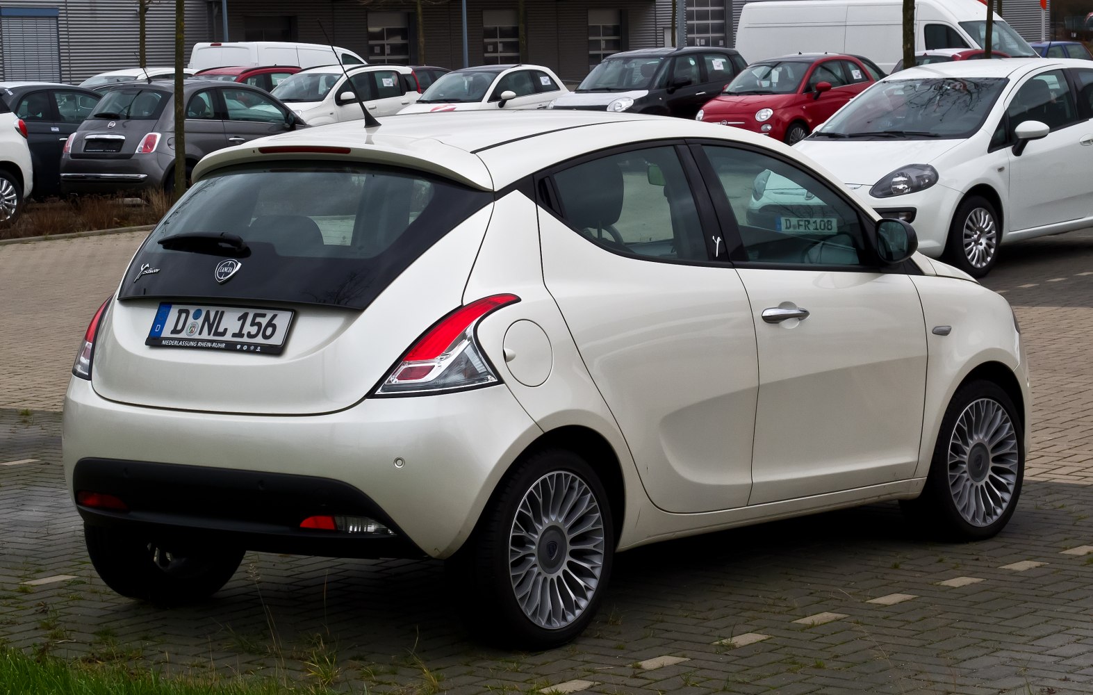 Rear view of compact hatchback with distinctive tail lights and rear spoiler