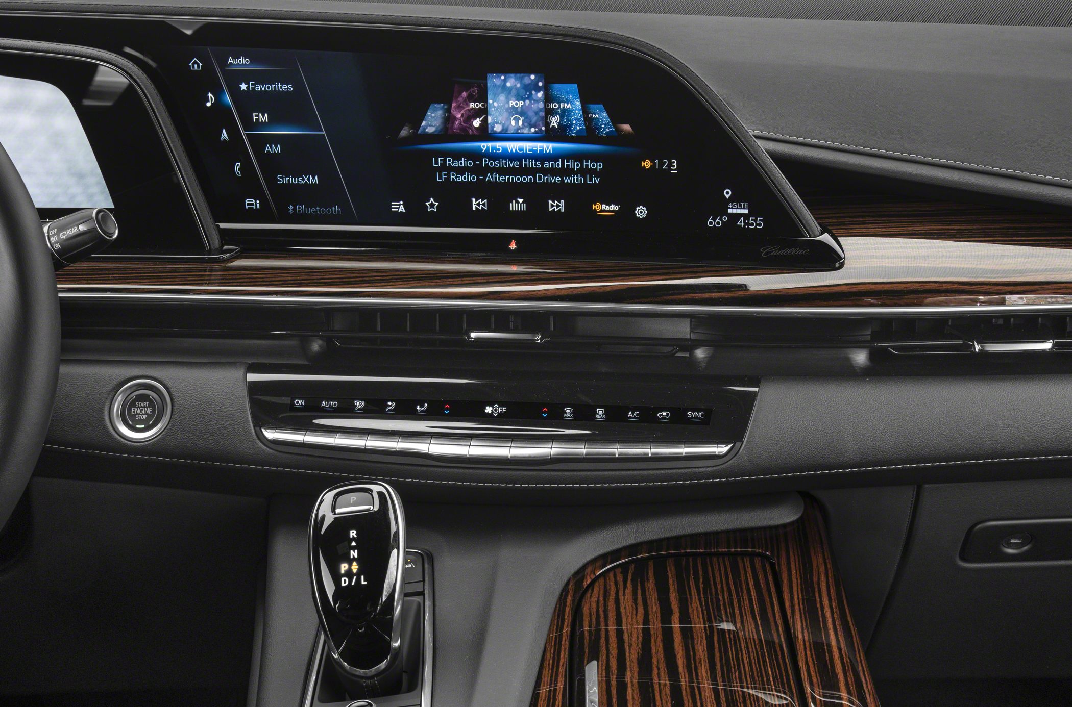 Digital touchscreen infotainment and sleek gear selector with wood trim