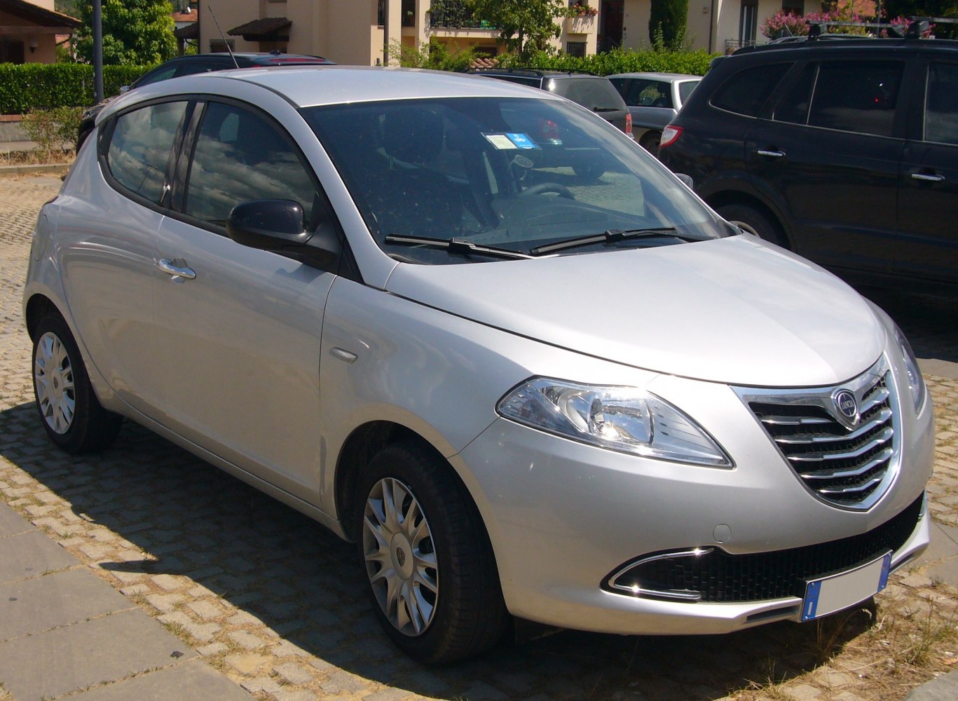 Silver hatchback with distinctive front grille and headlights.