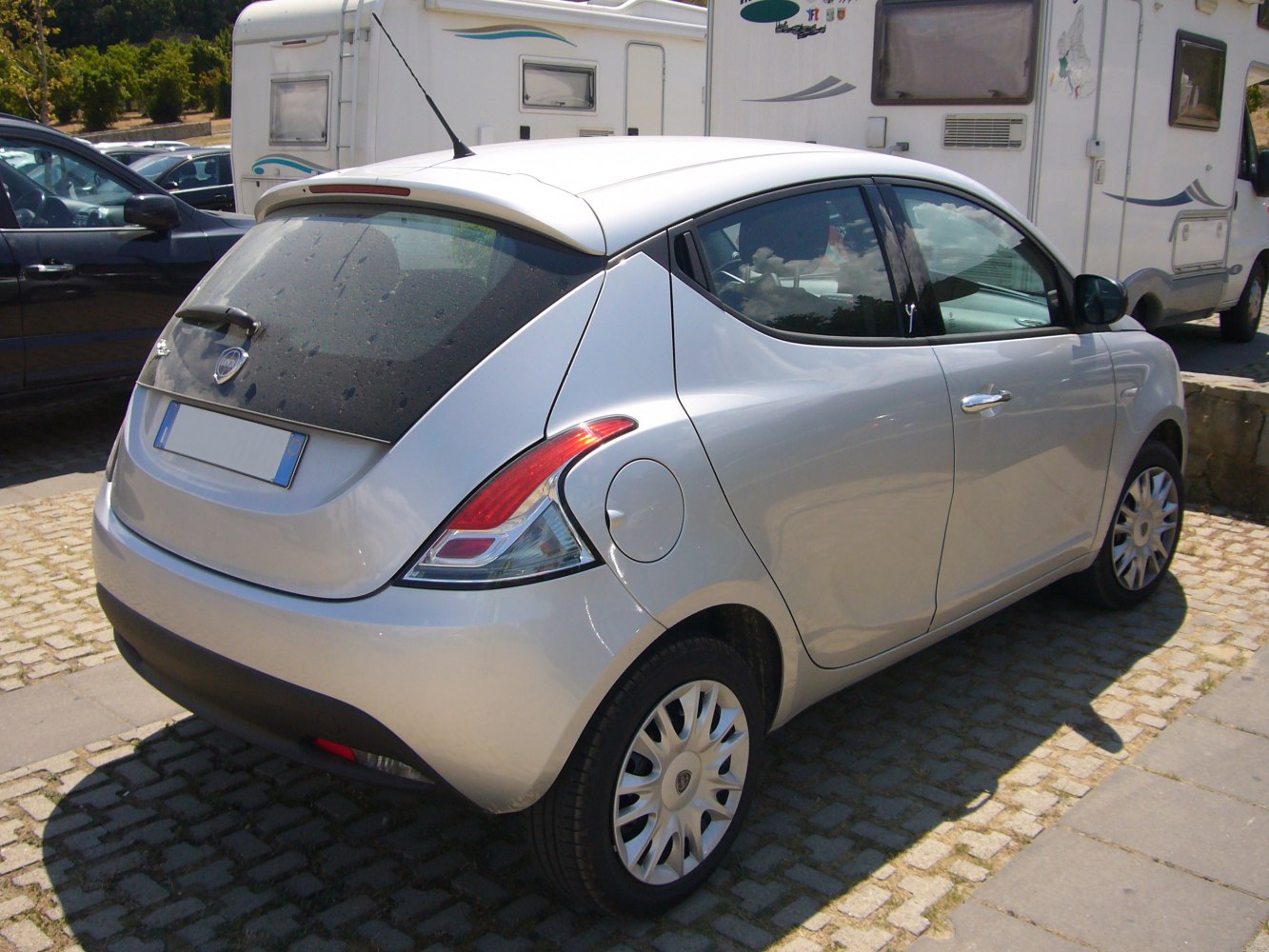 Rear-side profile showing unique tail lights and rear spoiler on compact hatchback.