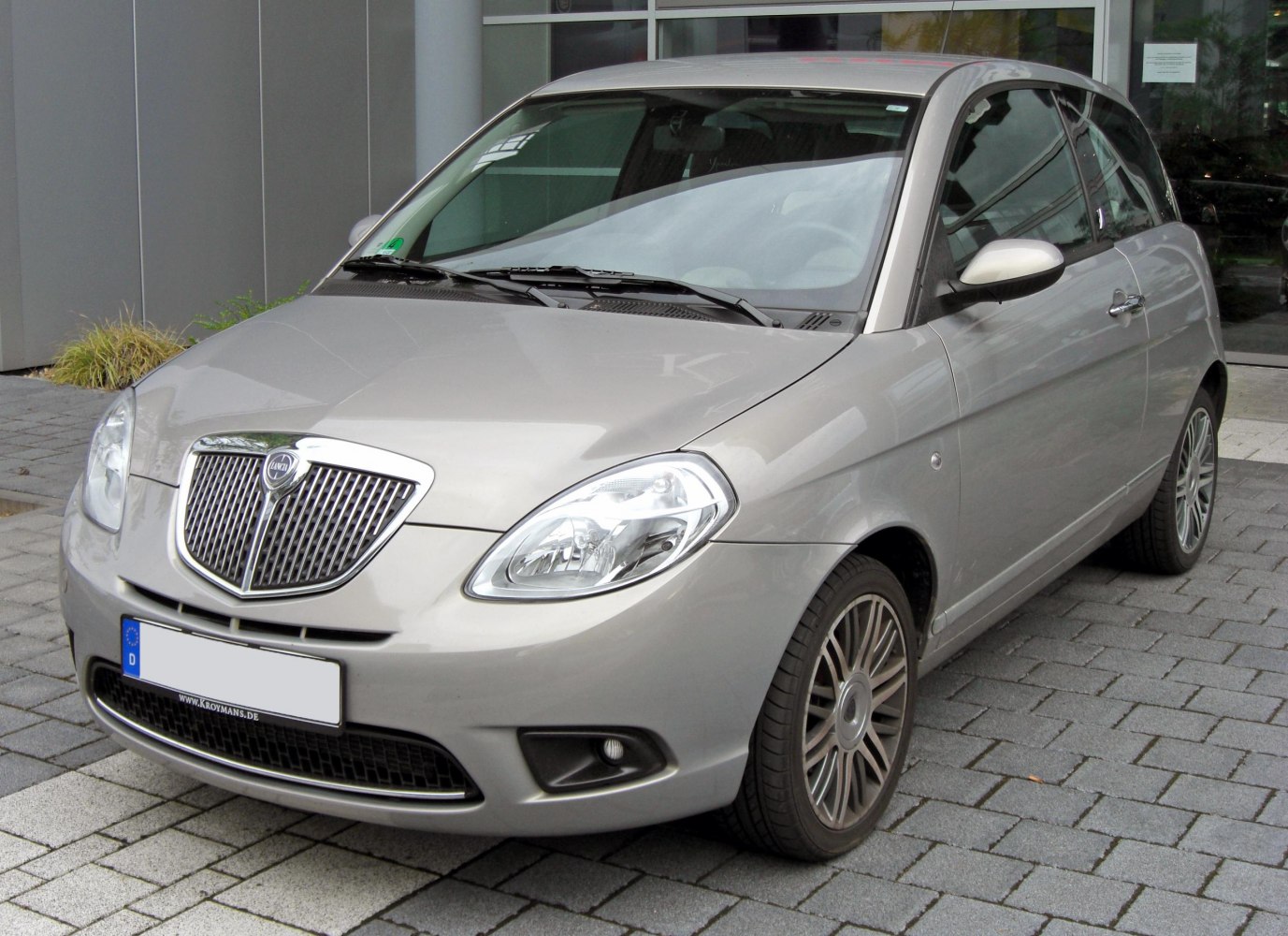 Front 3/4 view of compact hatchback with distinctive grille and headlights