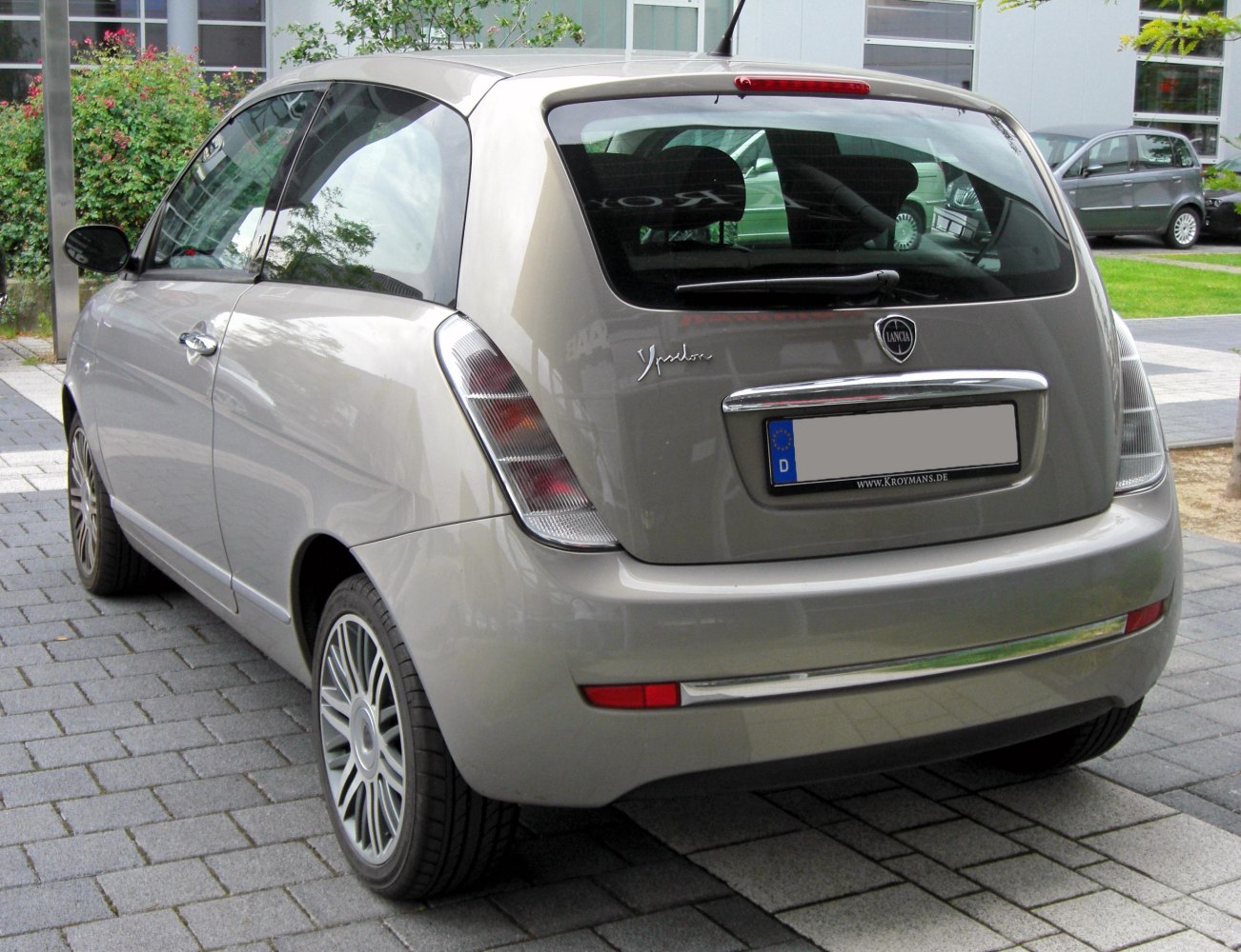 Rear view of a small hatchback with distinctive vertical taillights and chrome trim