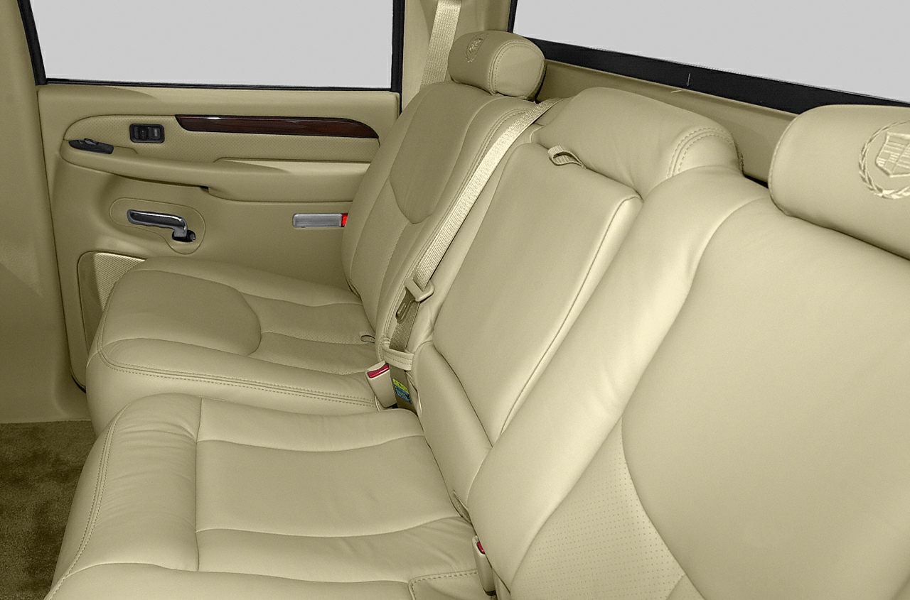 Beige leather rear seats with Cadillac emblem and detailed stitching