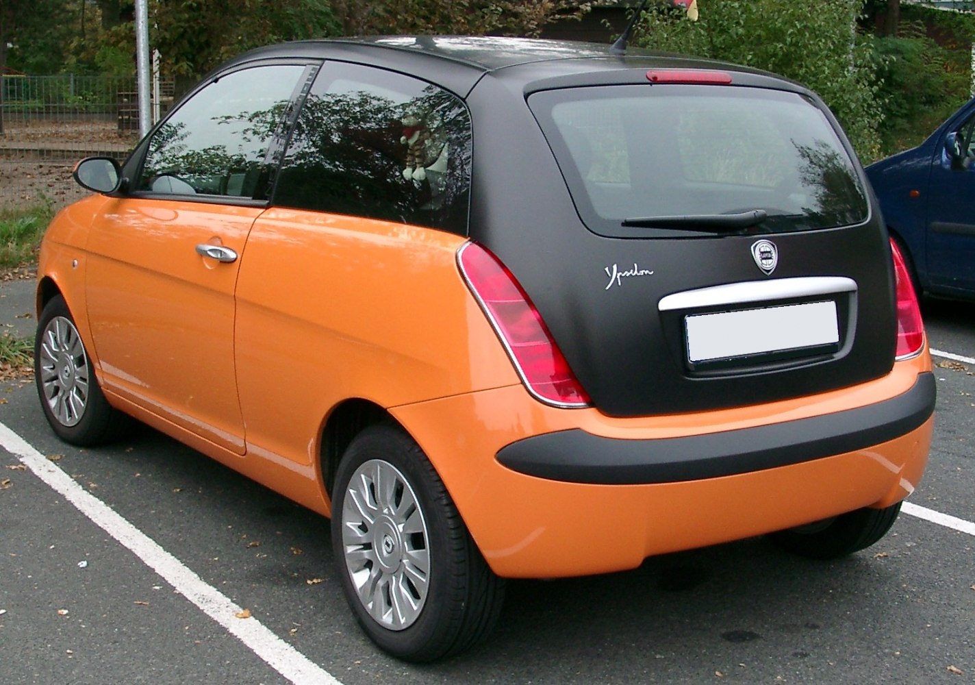 Rear and side view of compact hatchback with two-tone paint