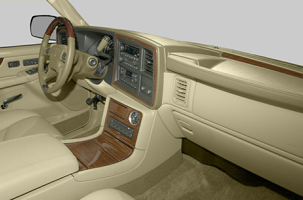 Luxury interior with wood trim, dashboard, steering wheel, and center console.