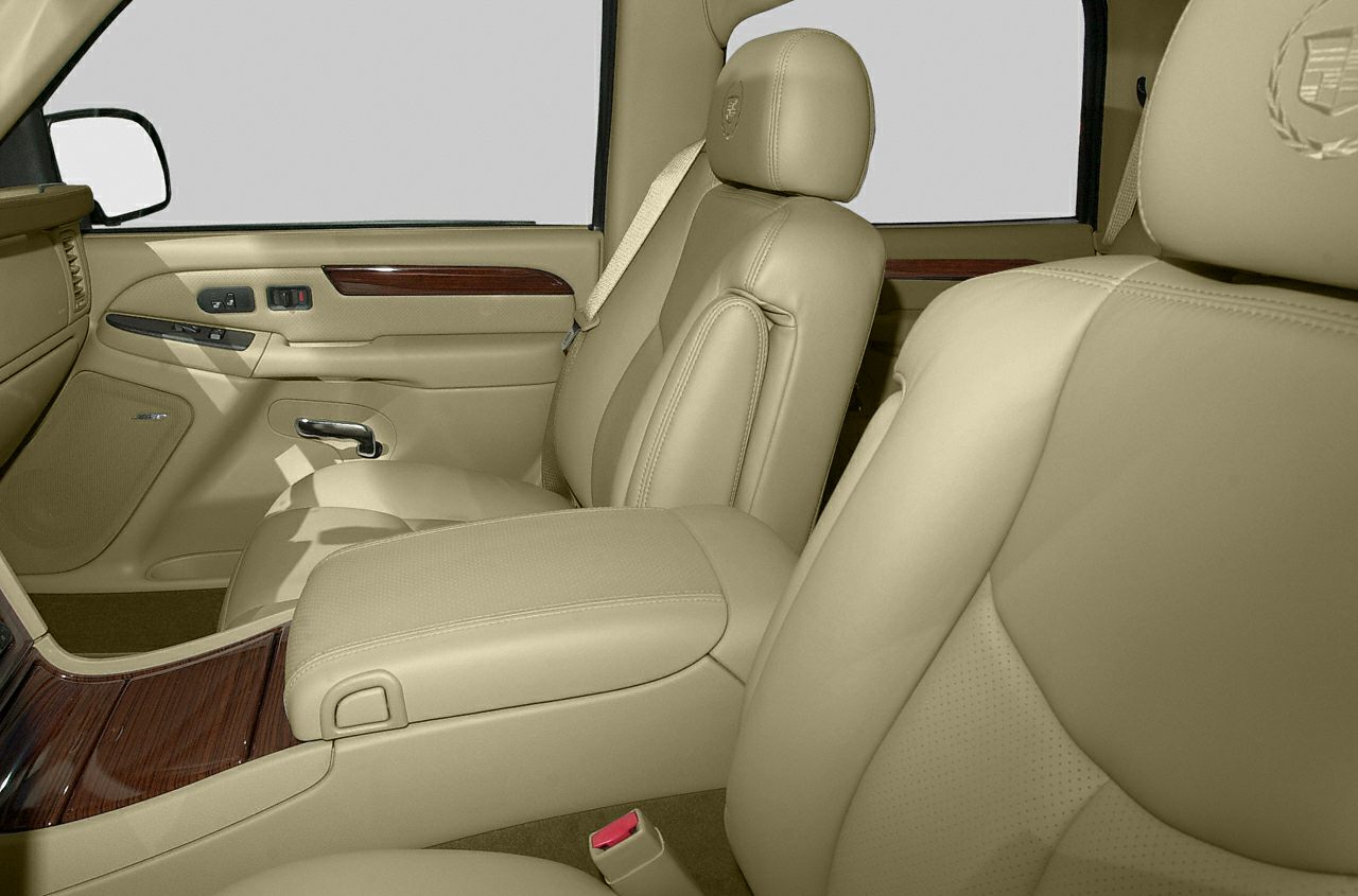 Beige leather seats with wood trim and detailed stitching in luxury interior