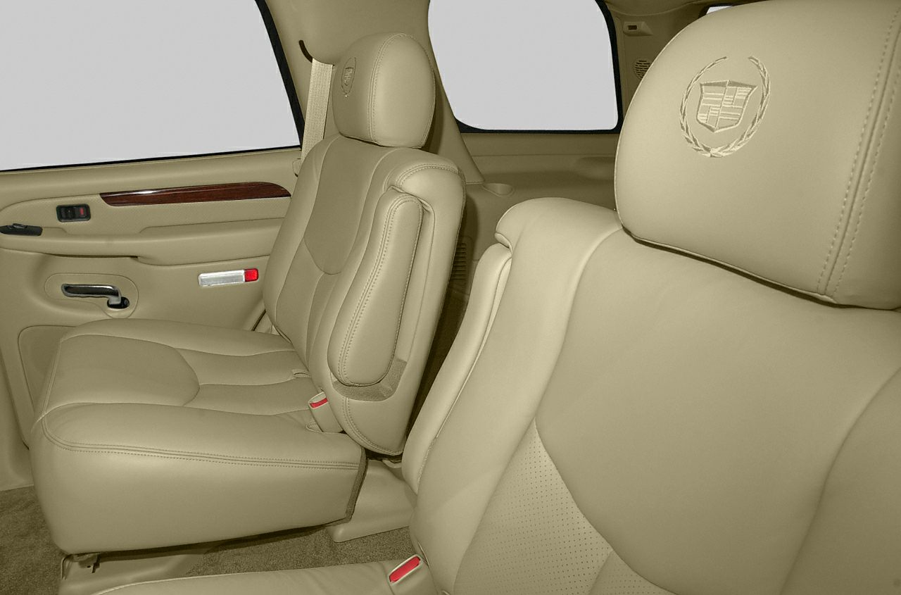 Beige leather interior seats with embossed Cadillac emblem headrests