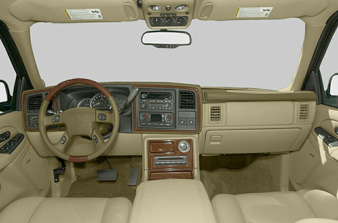 Beige interior with wood-trimmed dashboard and steering wheel.
