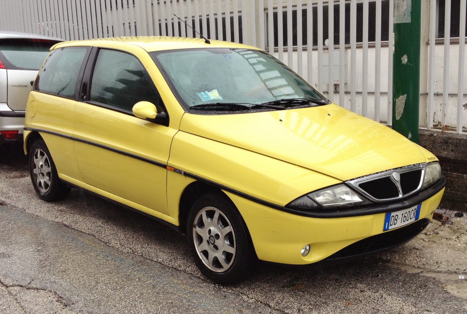 Compact yellow hatchback with distinctive front grille and rounded headlights