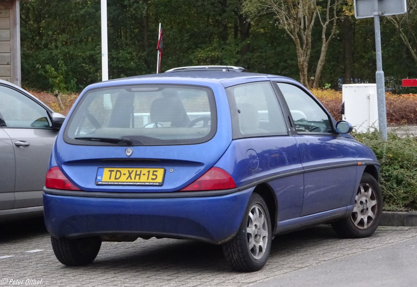 Rear view of compact hatchback with distinct taillights and curved hatch glass.