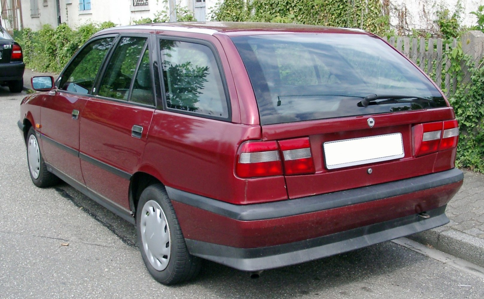 Rear and side of red station wagon with rear window wiper