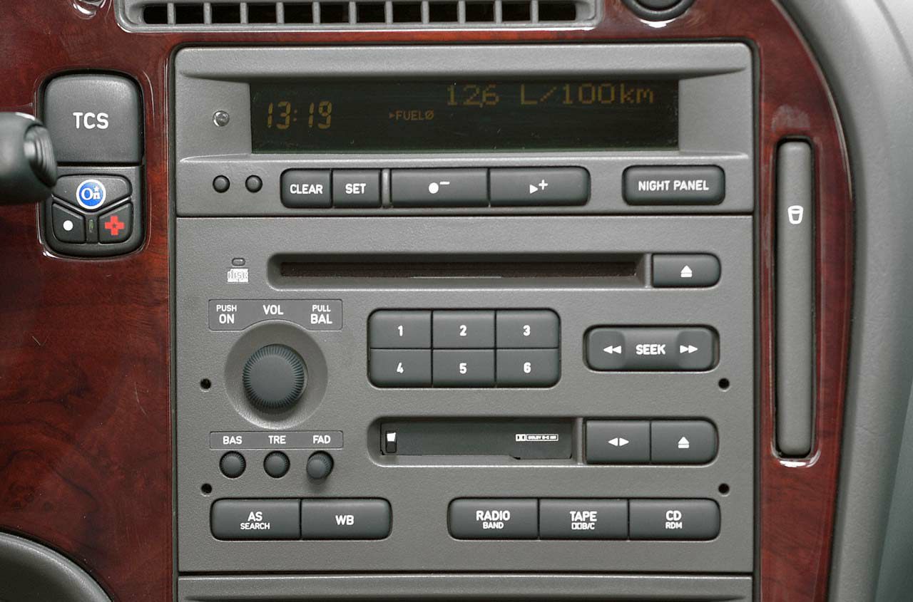 Car interior audio control panel with radio, tape, and CD player buttons
