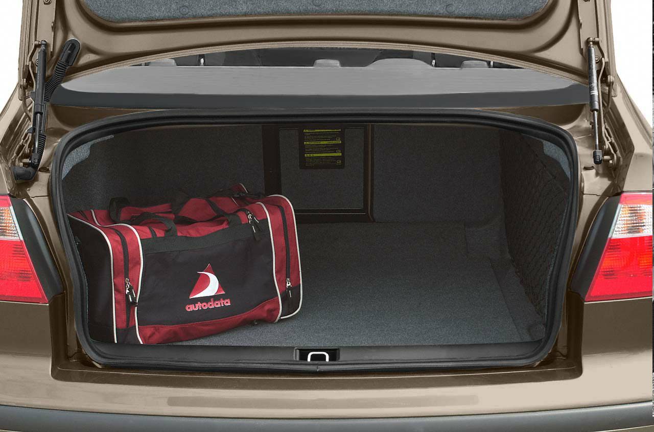 Spacious open trunk with luggage compartment and red duffel bag