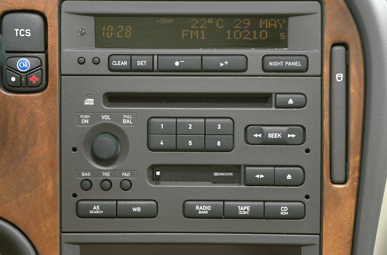 Car dashboard audio control panel with radio, cassette, CD, and display.