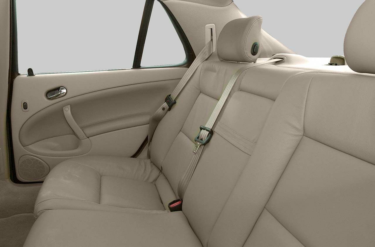 Beige leather rear seats with seat belts and door panel